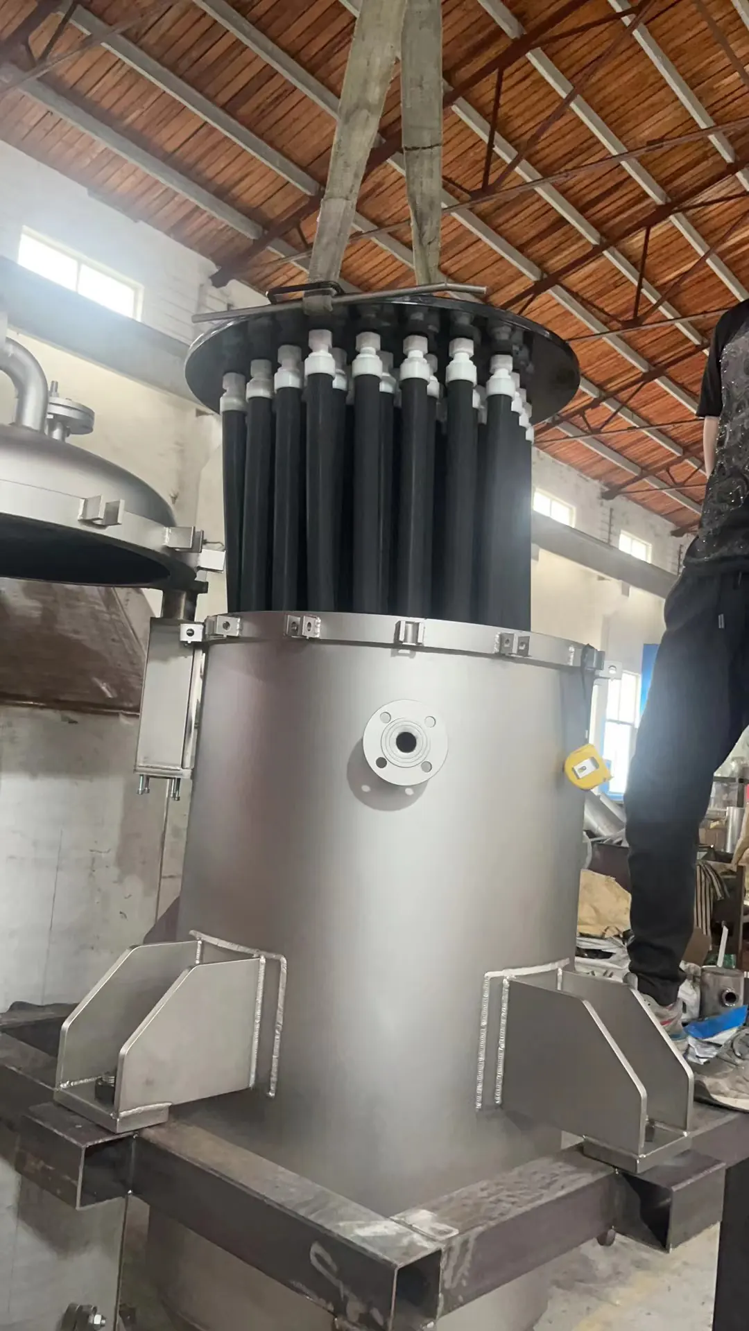 Candle bundle lifted from a vertical filter vessel